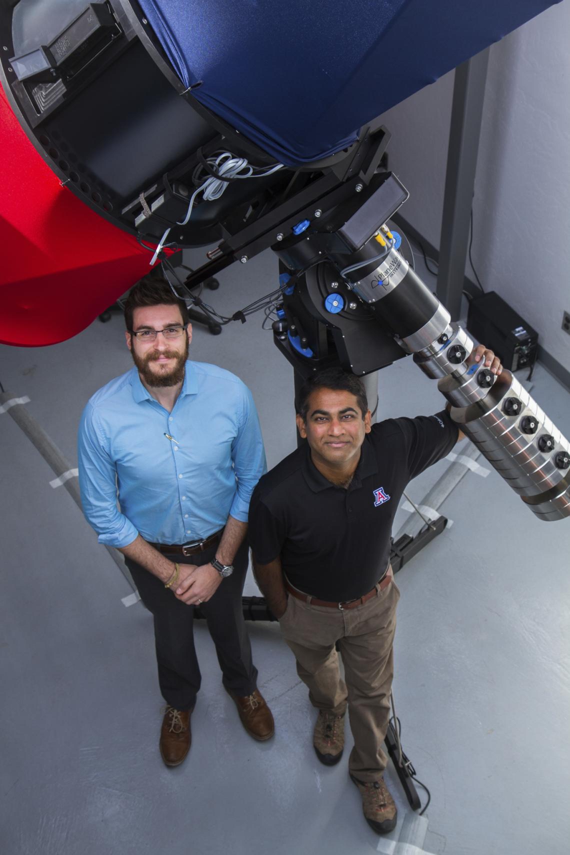 Vishnu Reddy and Tanner Campbell stand next to the RAPTORS telescope at the UA's Kuiper Space Sciences building. They would like to mount an optical sensor system on the telescope in the future. Vishnu Reddy and Tanner Campbell stand next to the RAPTORS telescope at the UA's Kuiper Space Sciences building. They would like to mount an optical sensor system on the telescope in the future.